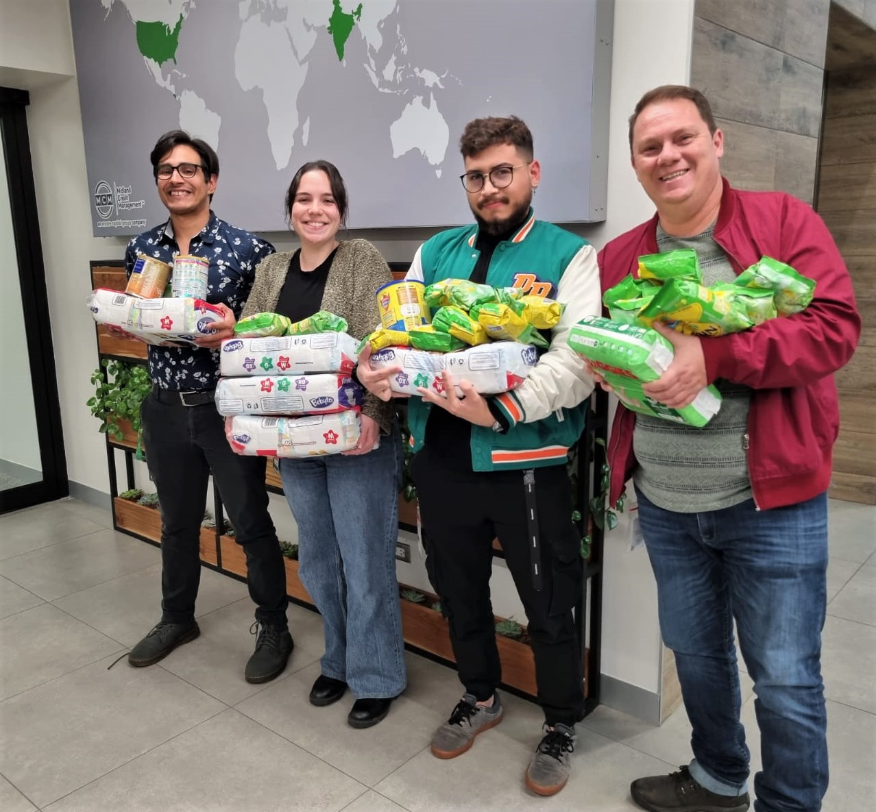 Encore capital group team members posing with the items they are donating